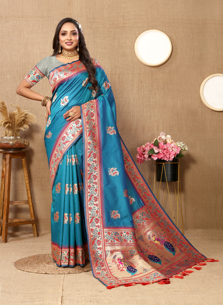 Sea-blue Paithani saree with rich zari border and tassels, ideal for festive events.