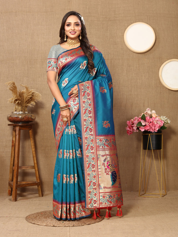 Classic sea-blue silk saree with intricate zari and chic tassels, perfect for weddings and ceremonies.