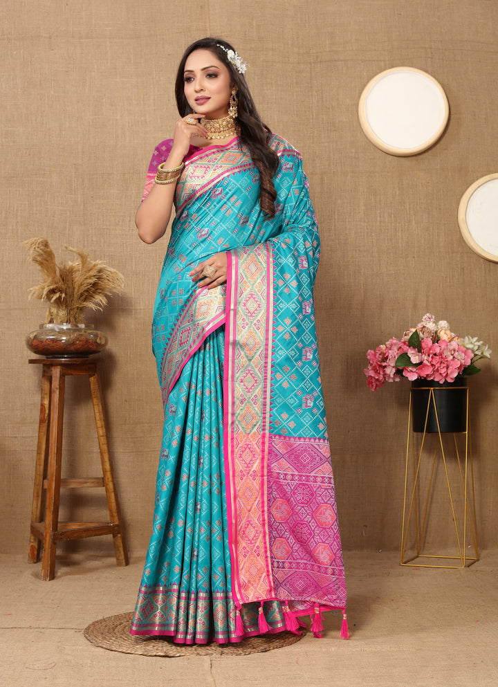 Rich teal blue Designer Patola silk sari with intricate zari pallu, perfect for cultural gatherings.