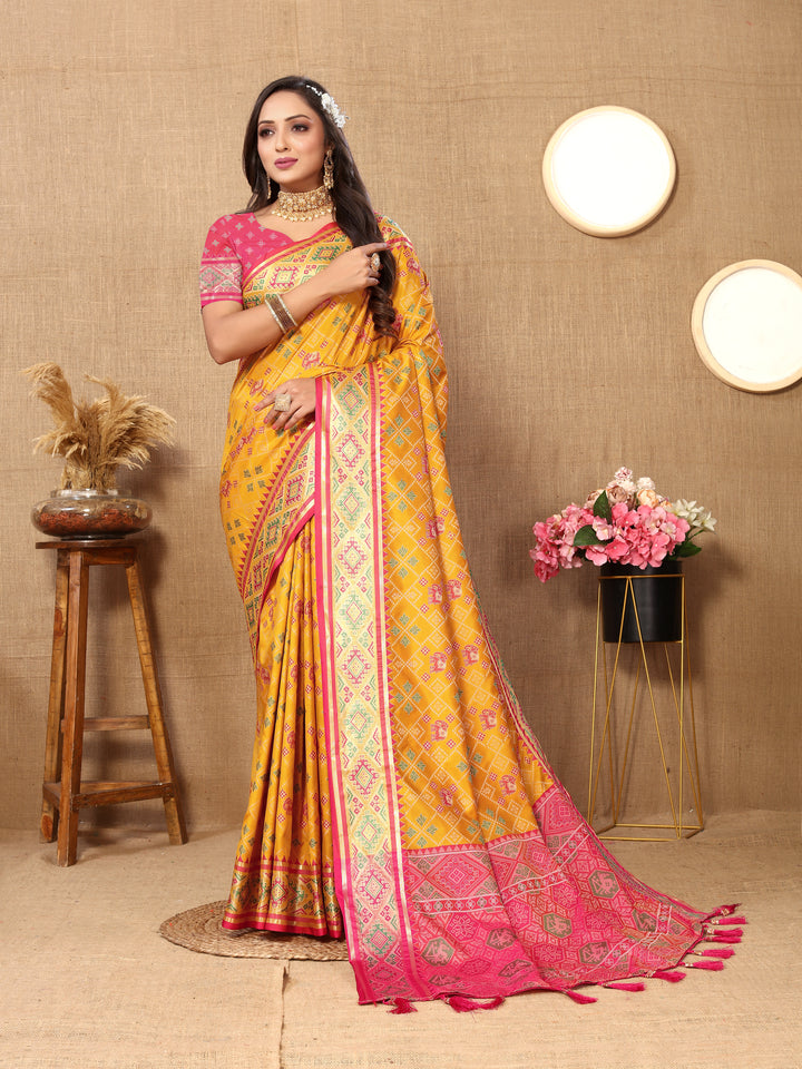 Yellow Patola silk sari with luxurious zari pallu detail, perfect for weddings and celebrations.