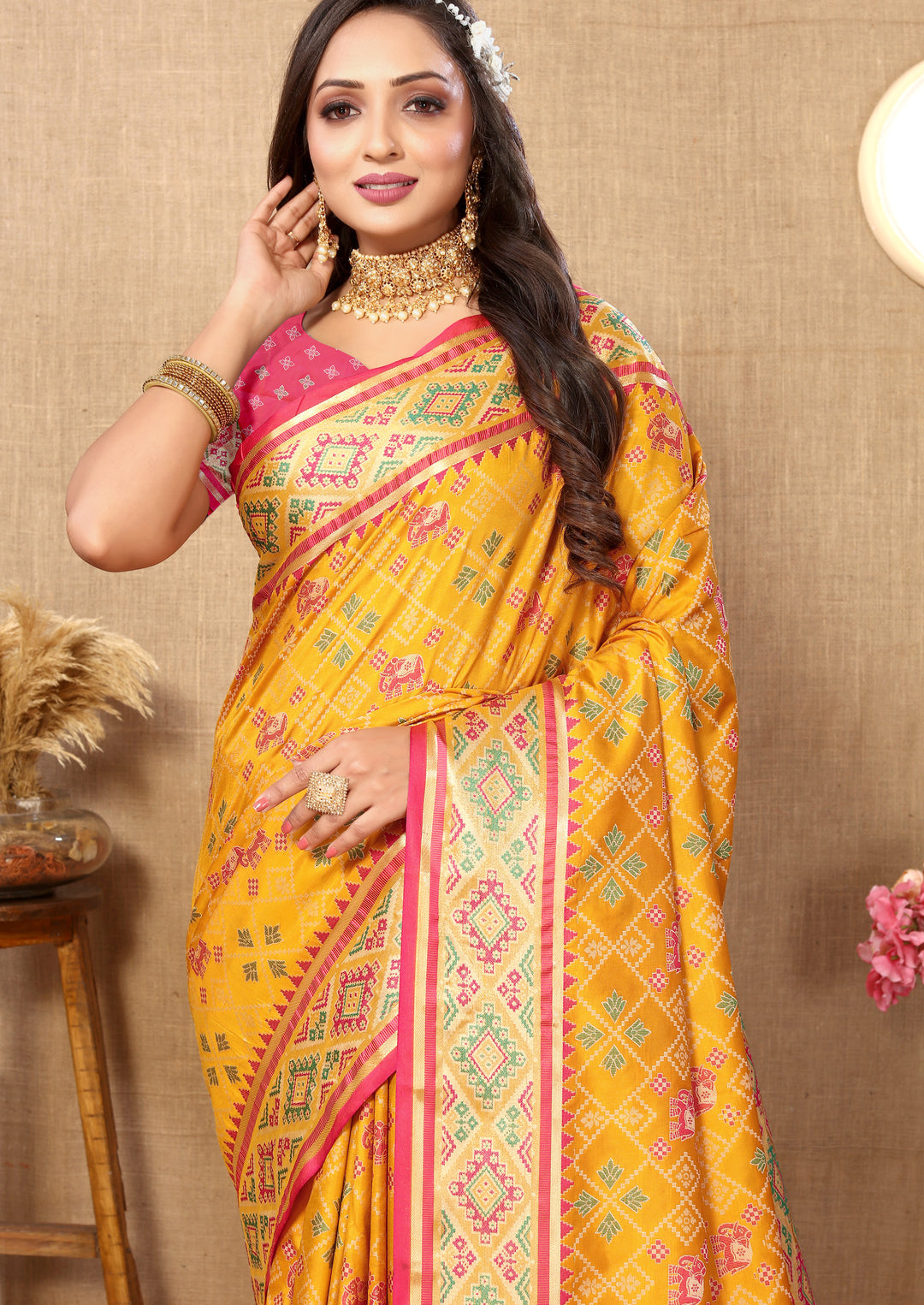 Classic yellow Patola silk sari featuring beautiful zari accents and intricate pallu, ideal for cultural gatherings.