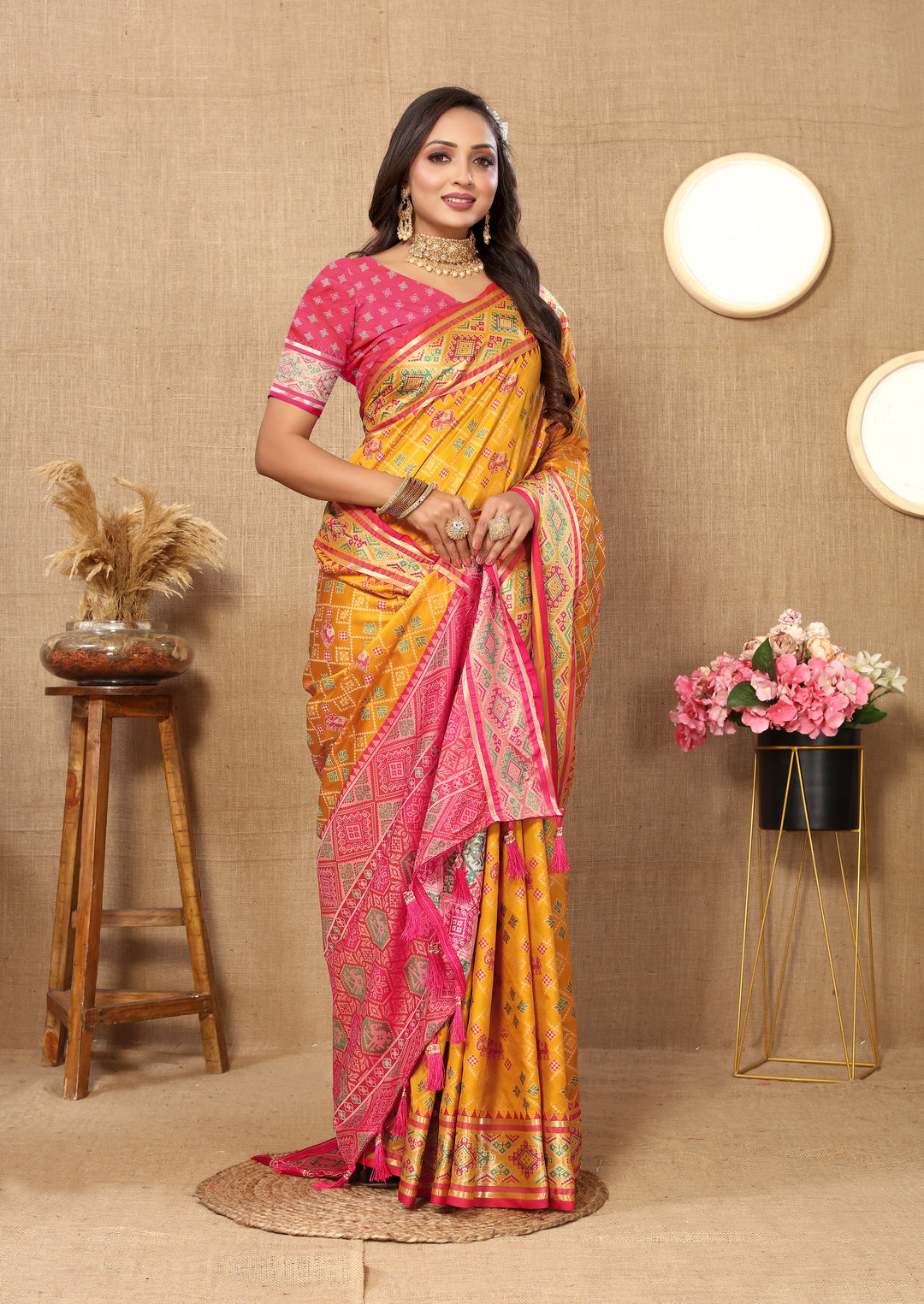 Stylish yellow Designer Patola silk sari with detailed pallu and shimmering zari, perfect for grand events.