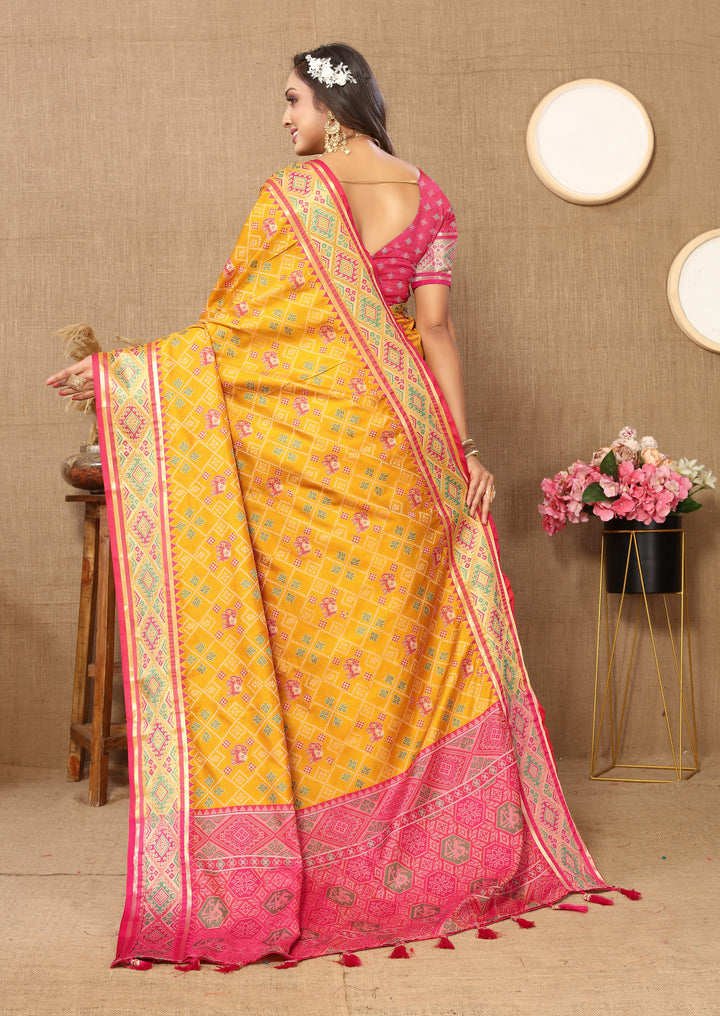 Bright yellow Patola silk sari with exquisite zari pallu detail, ideal for special Indian occasions.