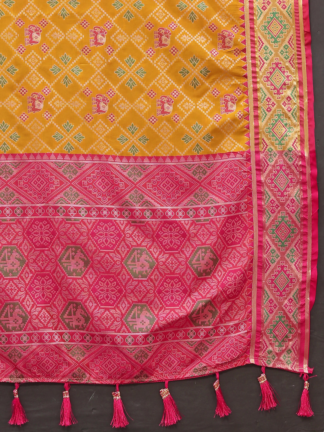 Charming yellow Patola silk sari with luxurious pallu and zari work, perfect for festive occasions.