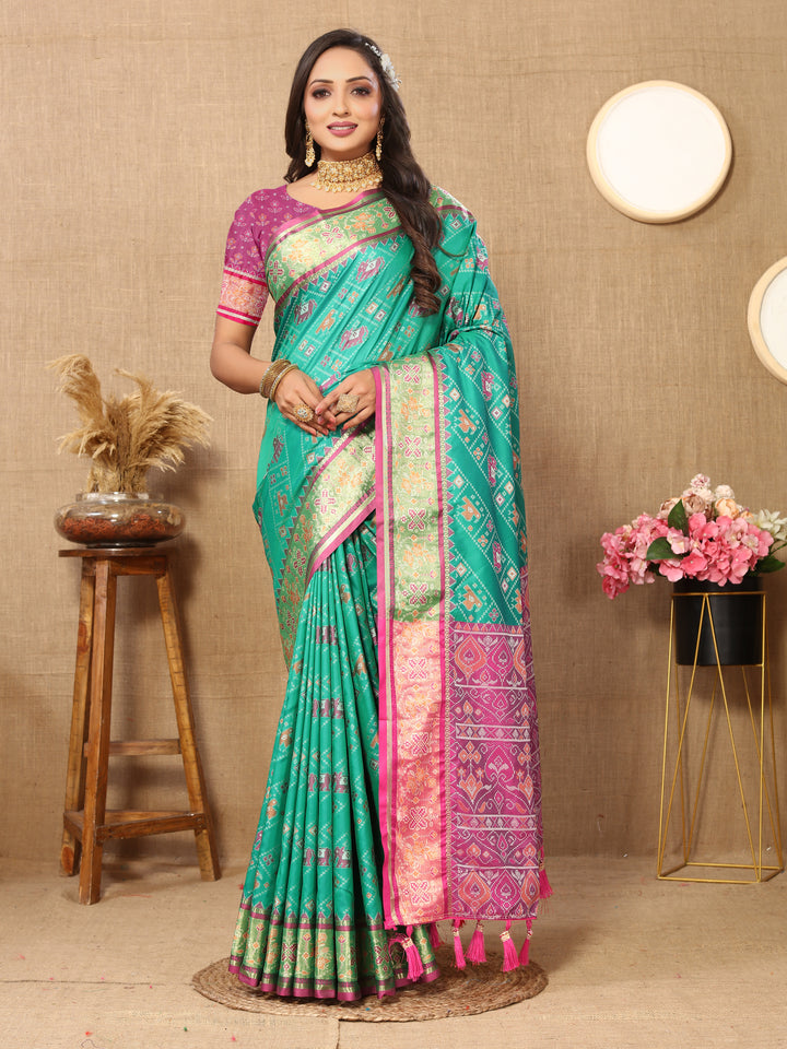 Elegant teal blue Patola silk saree with traditional Meenakari motifs and zari accents, ideal for festive celebrations.