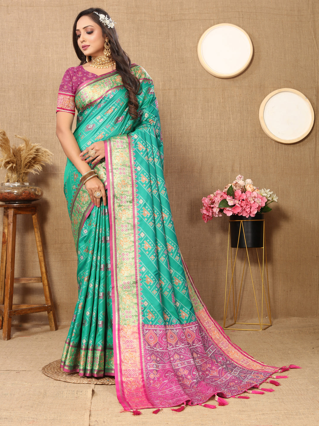 Stunning teal blue Patola silk saree featuring Meenakari and zari work, perfect for weddings and cultural celebrations.