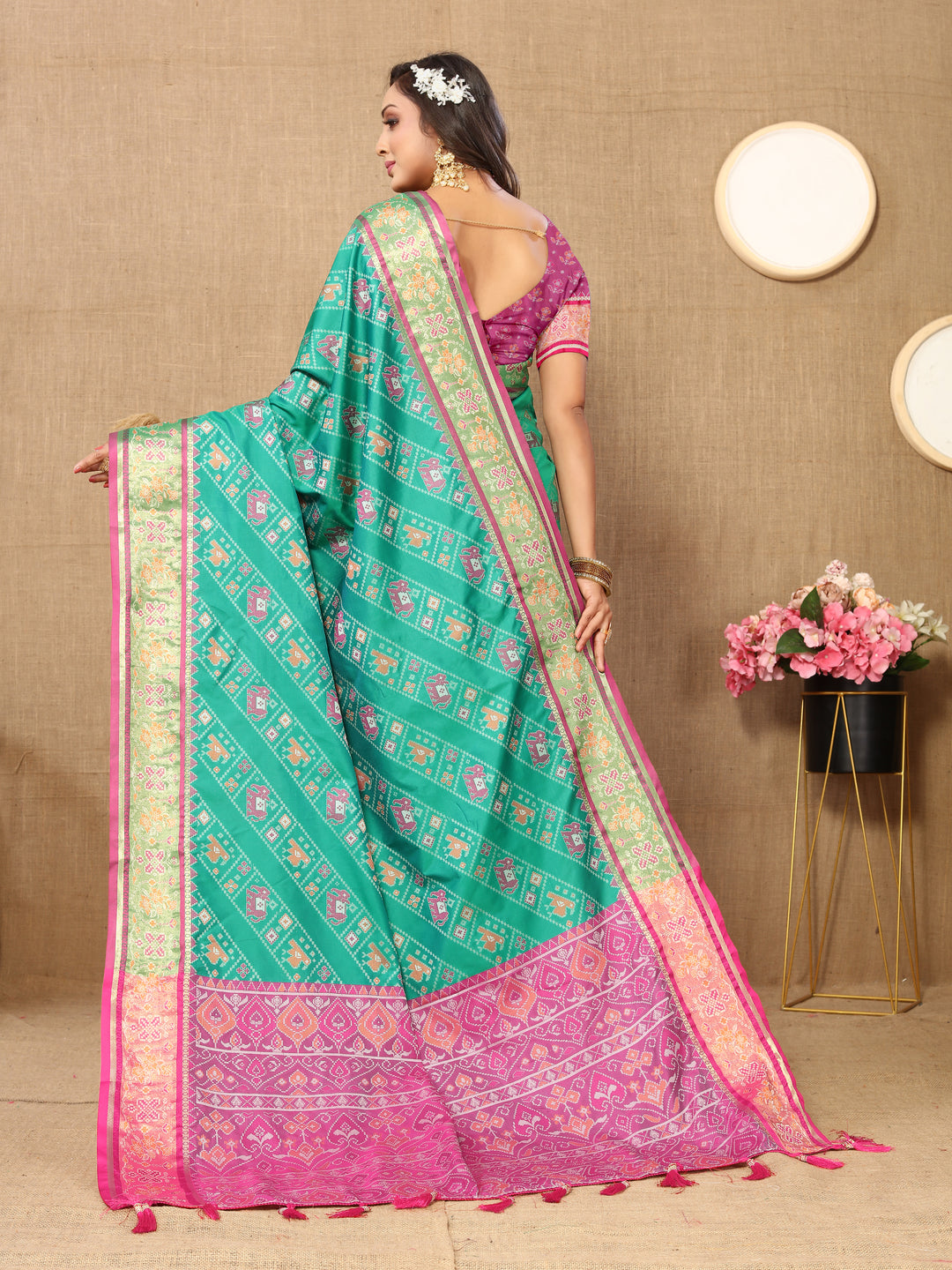 Stunning sea green saree in Patola silk with Meenakari and zari detailing, ideal for cultural events.