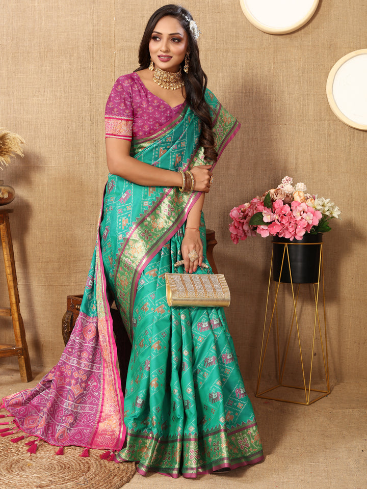 Elegant sea green Patola silk saree with Meenakari motifs and intricate zari accents, perfect for traditional weddings.