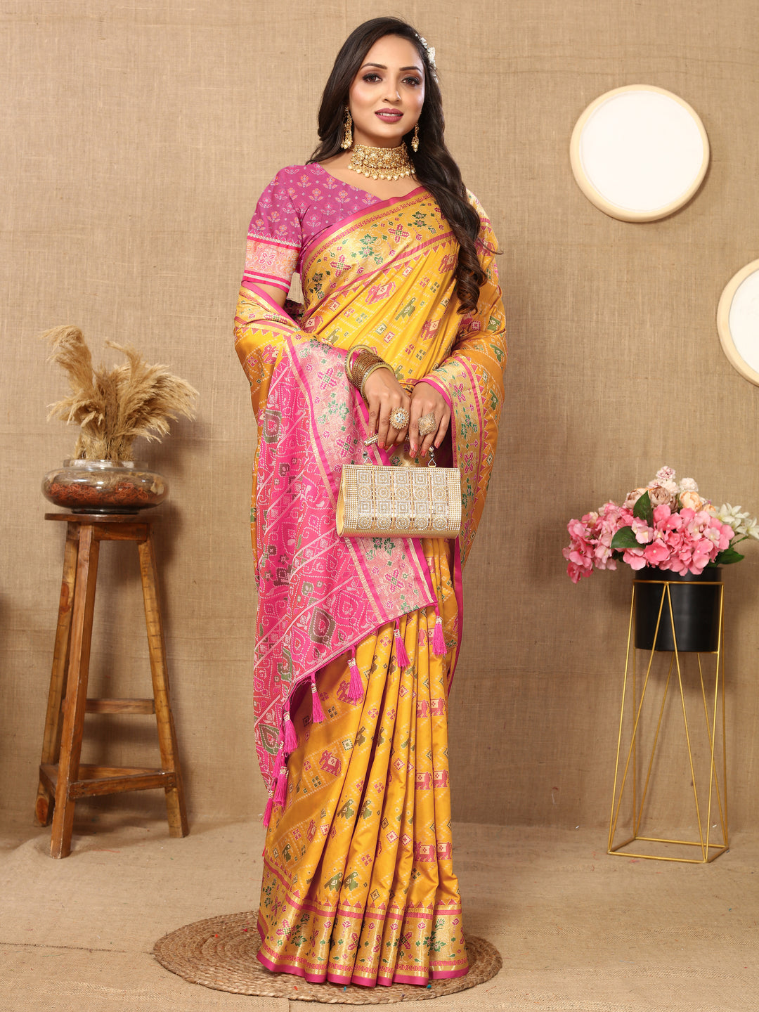 Gorgeous yellow Patola silk saree featuring detailed Meenakari motifs and zari accents, ideal for cultural celebrations.