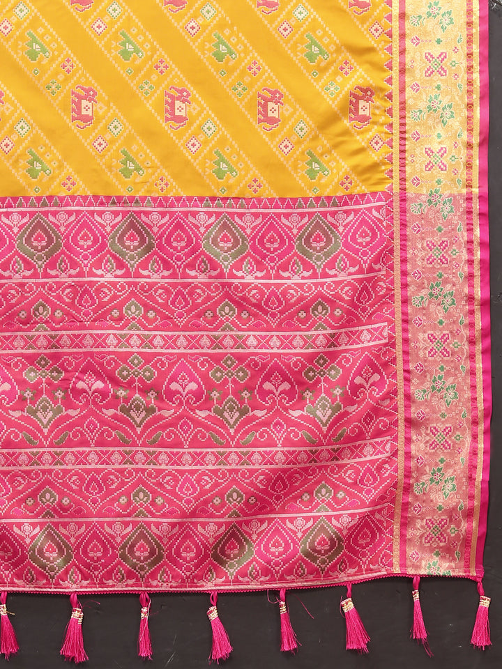 Beautiful yellow saree in Patola silk with Meenakari motifs and intricate zari detailing, perfect for festive wear.