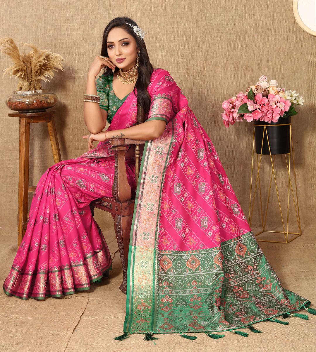 Elegant pink saree in Patola silk with luxurious Meenakari motifs and zari detailing, perfect for festive occasions.