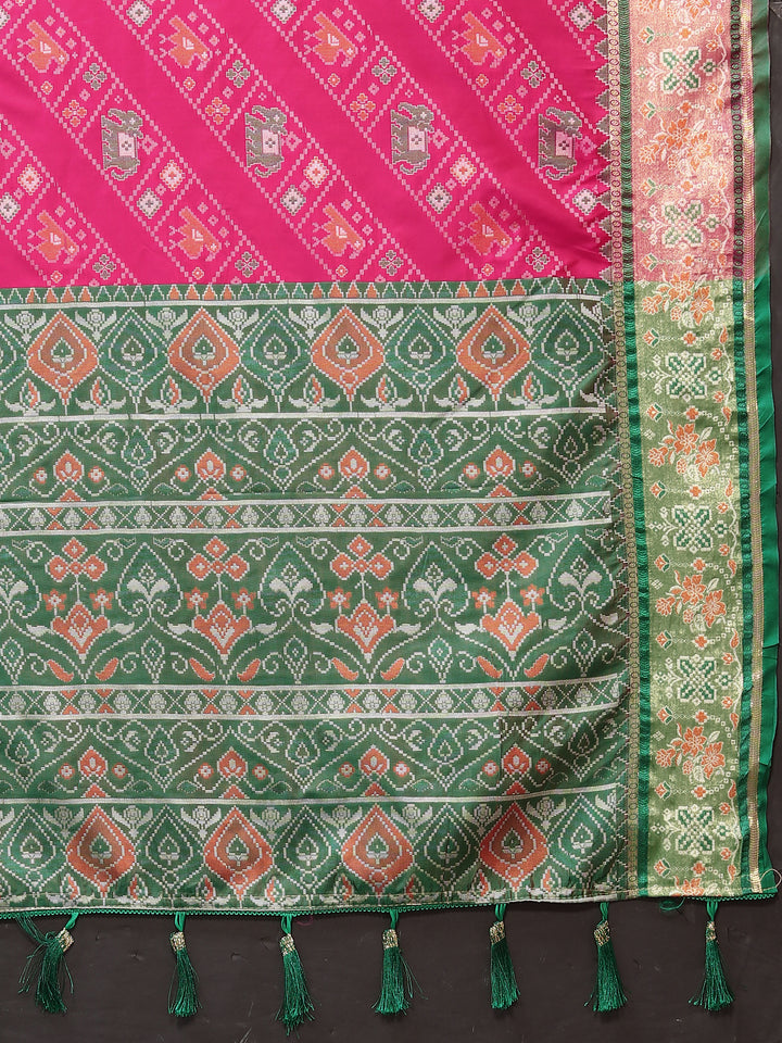 Beautiful pink Patola silk saree with intricate Meenakari detailing and zari accents, complemented by a silk blouse piece.