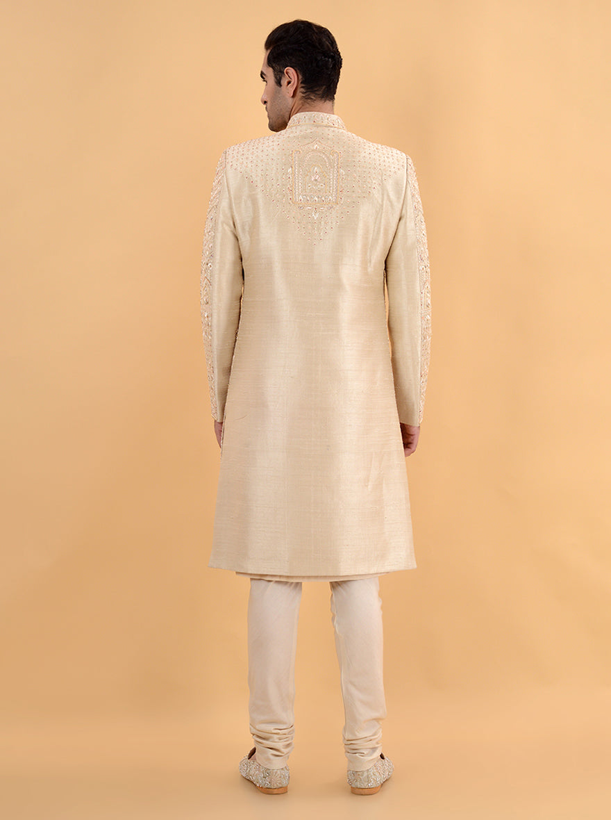 Look stunning at weddings in the USA with this beige silk sherwani, which features detailed embroidery and a comfortable silhouette, merging traditional elegance with contemporary flair.