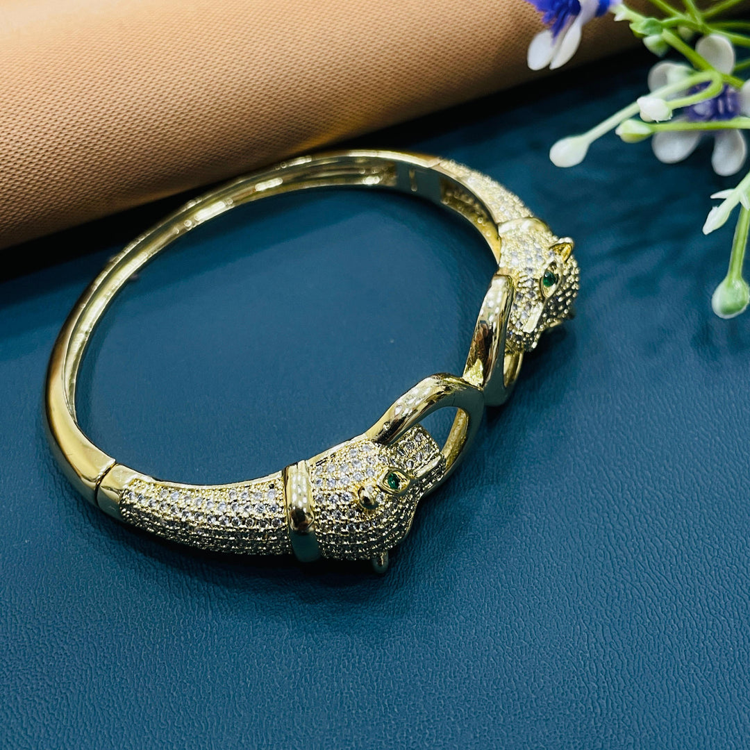 Golden bracelet with intricate filigree work, adding elegance to formal attire.