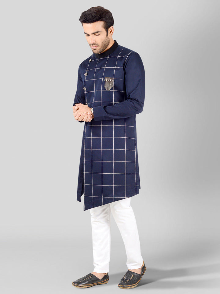 Men's navy blue kurta showcasing unique check embroidery and an asymmetric design, perfect for any occasion.