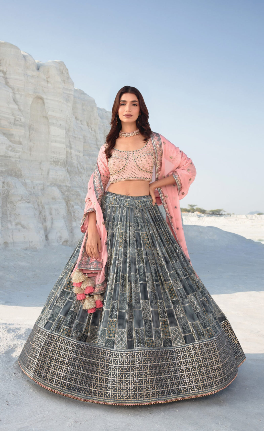 Elegant grey and pink lehenga choli featuring an embroidered blouse and matching dupatta, perfect for bridal wear.