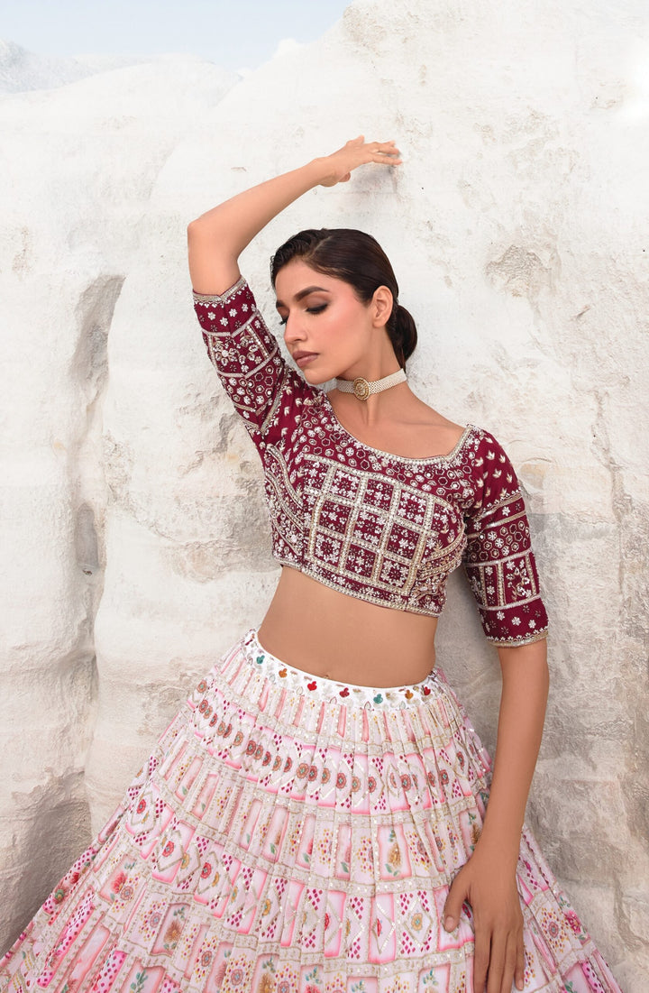 Stunning maroon and pink bridal lehenga featuring handcrafted embroidery, designed for a luxurious wedding experience.