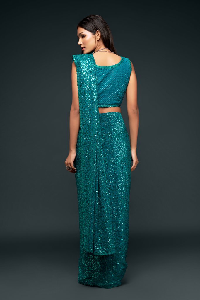 Teal Indian saree with beautiful sequins, a must-have fancy saree for weddings and traditional Indian sari celebrations.