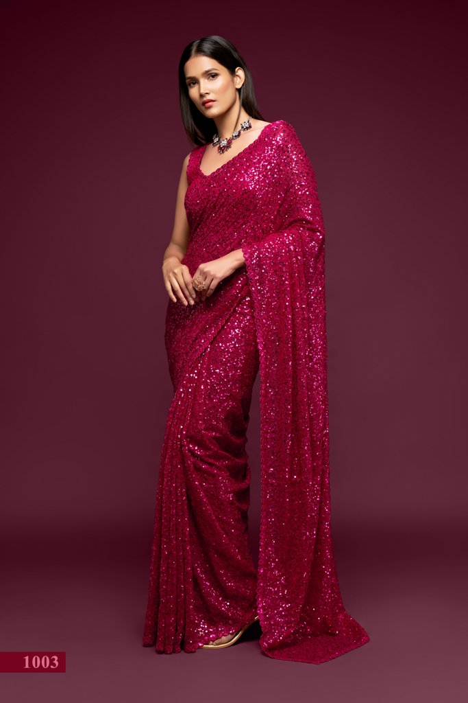 A striking hot pink saree embellished with intricate sequins embroidery, perfect for festive celebrations and as an Indian wedding saree.