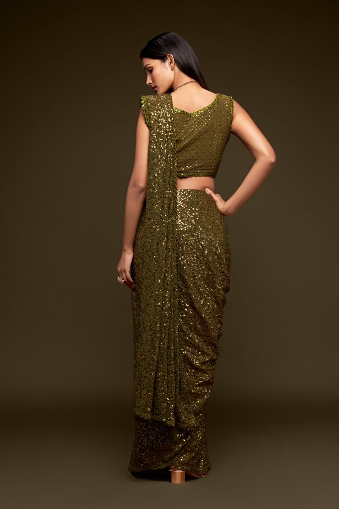 Olive Indian saree adorned with exquisite sequins, designed as a fancy saree for weddings and cultural gatherings.