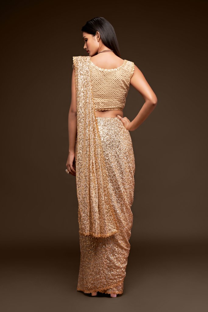 Beige Indian sari elegantly draped, adorned with glamorous sequins for a classic look at parties and weddings.