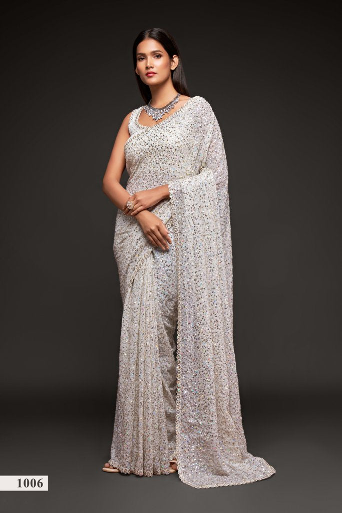 A stunning white faux georgette saree embellished with intricate sequins embroidery, perfect for elegant occasions.