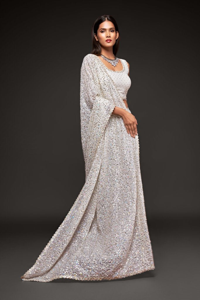 Exquisite white faux georgette saree adorned with shimmering sequins, designed for special celebrations.