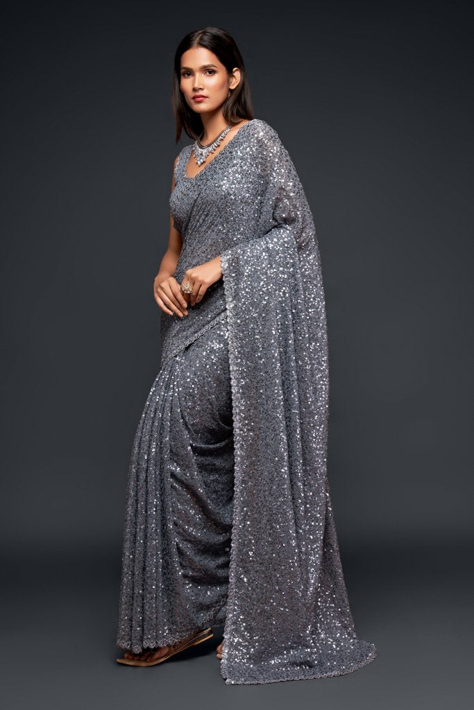 Grey Indian sari draped gracefully, featuring shimmering sequins that enhance its elegant design for festive occasions.