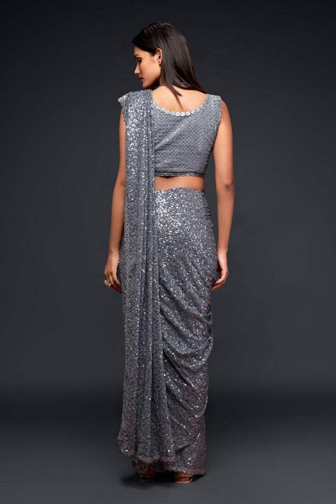 Gorgeous grey saadi featuring intricate sequins embroidery, complete with an unstitched blouse piece for customization as a latest saree.