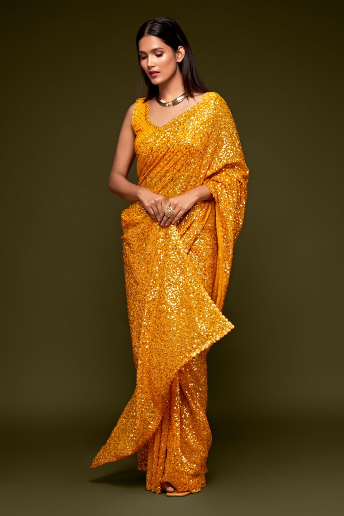 Bright yellow Indian sari beautifully draped, featuring glamorous sequins detailing for a cheerful look at parties and weddings.