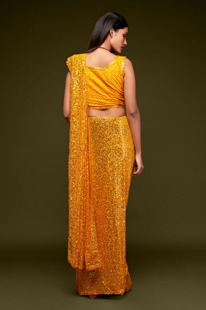 Gorgeous yellow saadi featuring detailed sequins embroidery, complete with an unstitched blouse piece for customization in your collection of latest sarees.