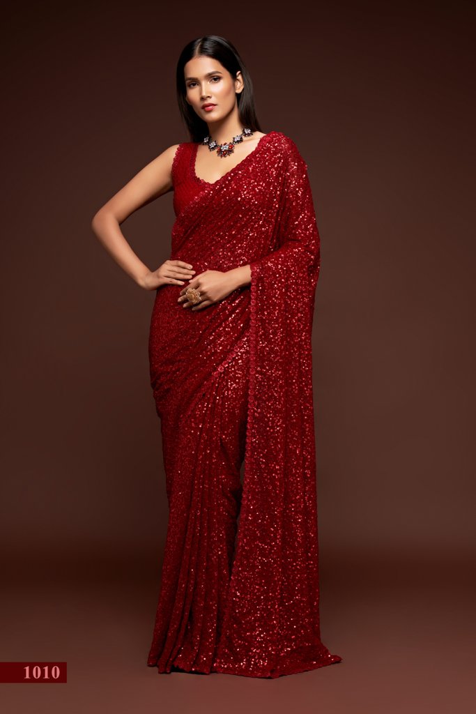 A striking ruby red saree adorned with intricate sequins embroidery, perfect for festive occasions as an Indian wedding saree.