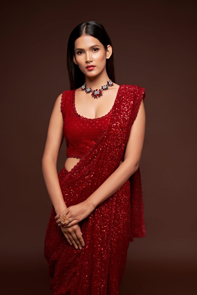 Beautiful ruby red sadi featuring intricate sequins embroidery, ideal for weddings and special celebrations.