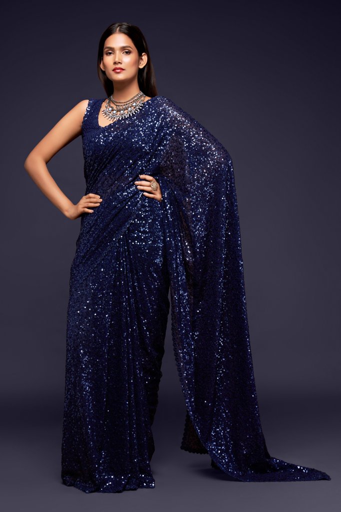 Dark blue Indian sari elegantly draped, featuring glamorous sequins detailing for a striking look at parties and weddings.