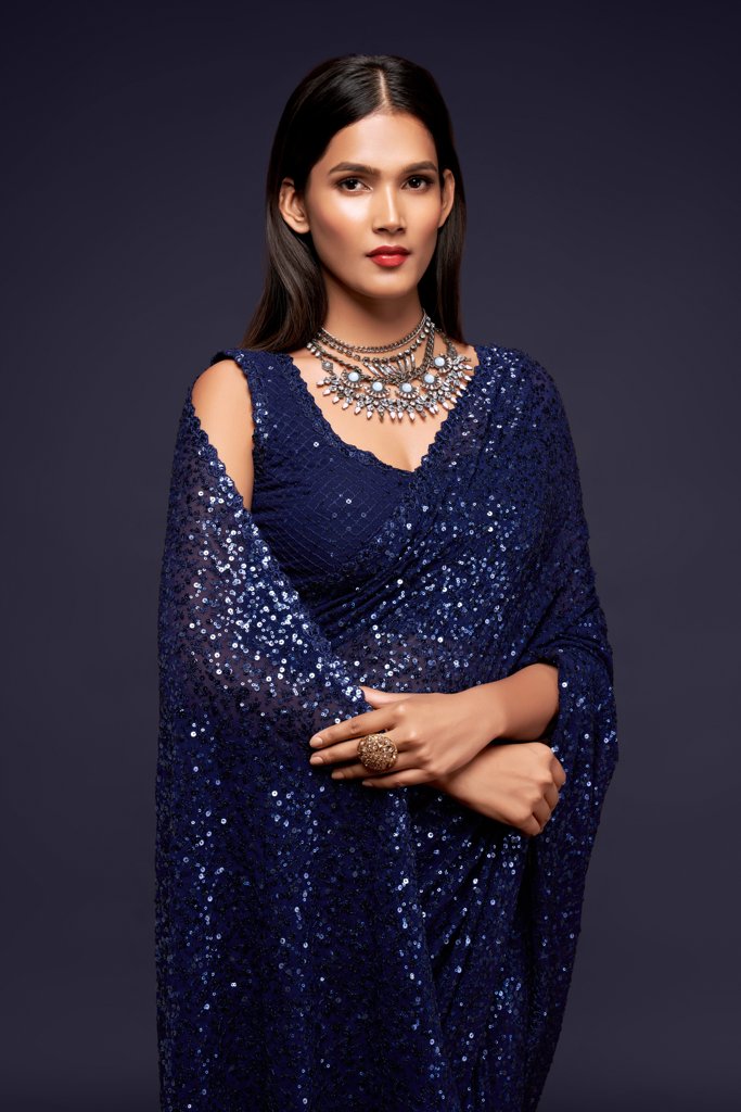 Exquisite dark blue Indian saree adorned with shimmering sequins, designed to impress at festive celebrations and gatherings.