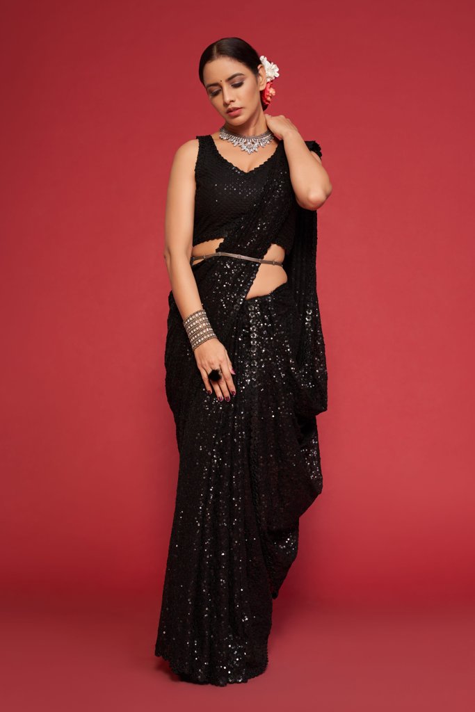 Elegant black Indian sari beautifully draped, featuring stunning sequins detailing for a sophisticated look at parties.