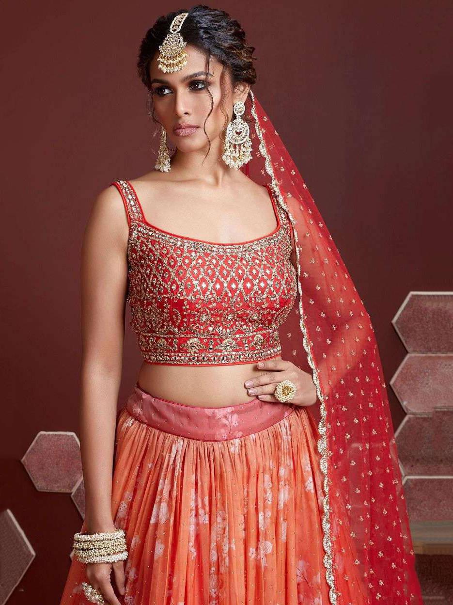 Elegant orange organza silk lehenga with ruffle work and embroidery.