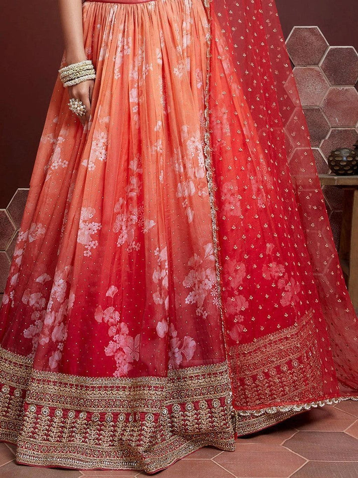 Beautiful orange lehenga with net designer dupatta and ruffle details.