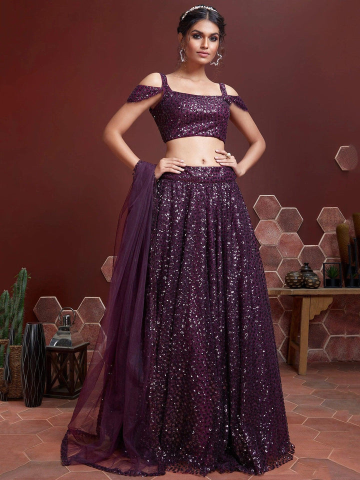 Elegant purple net lehenga choli with sequins embroidery and heavy work.