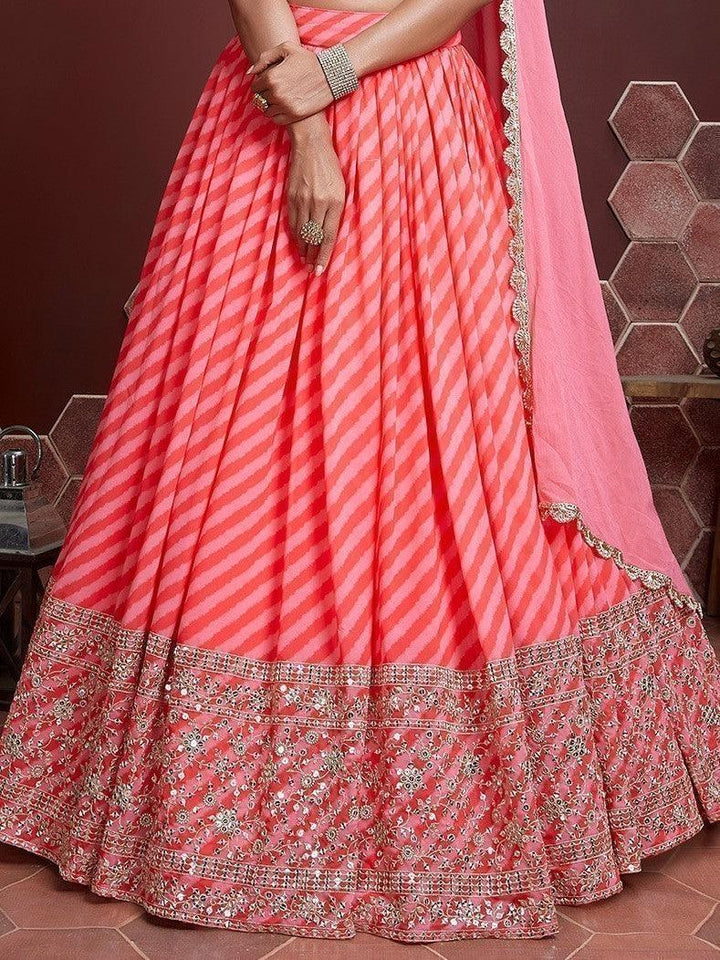 Elegant peach wedding lehenga with organza material and embroidery.