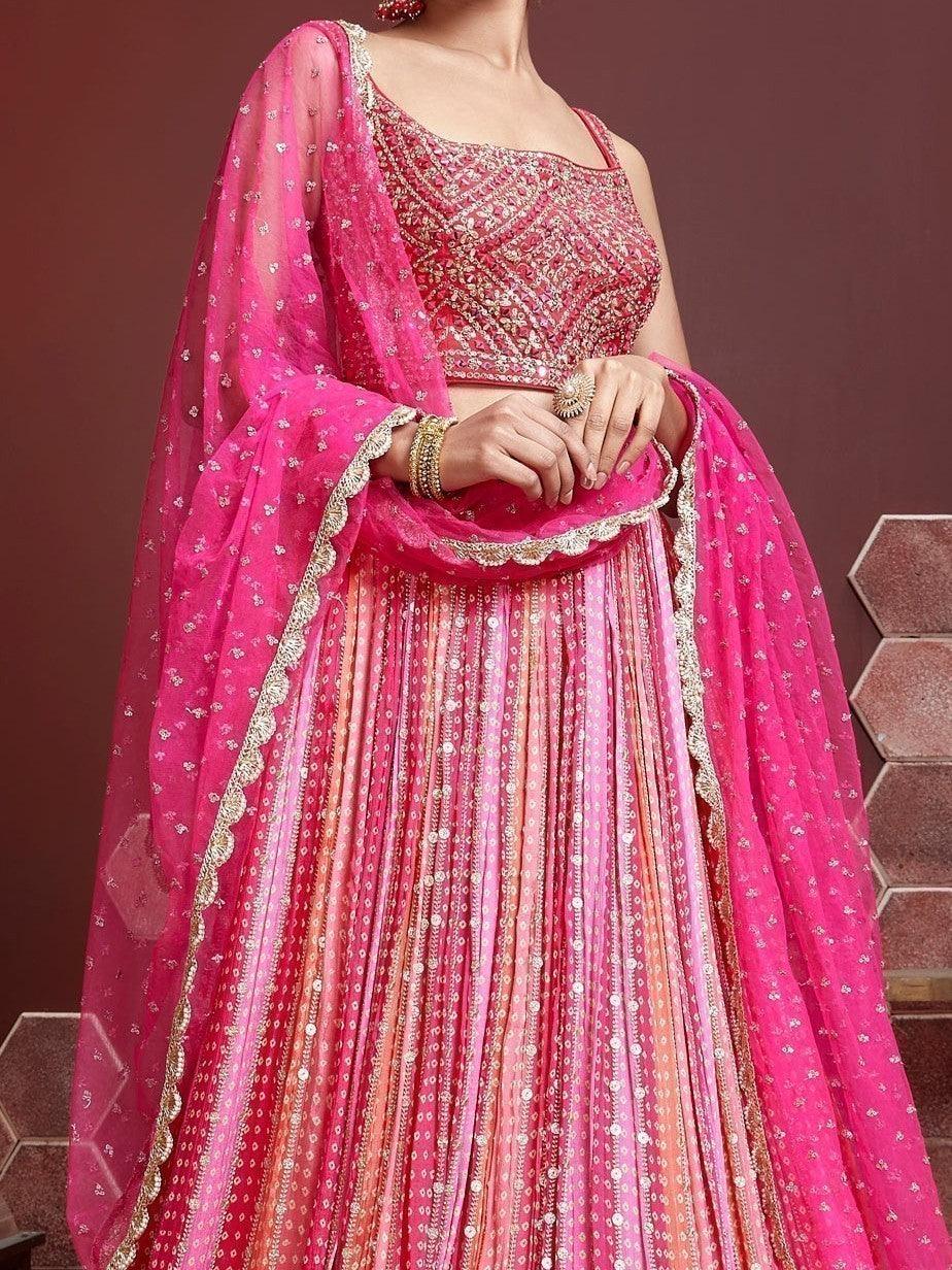 Pink wedding lehenga choli with matching net dupatta and lace border.