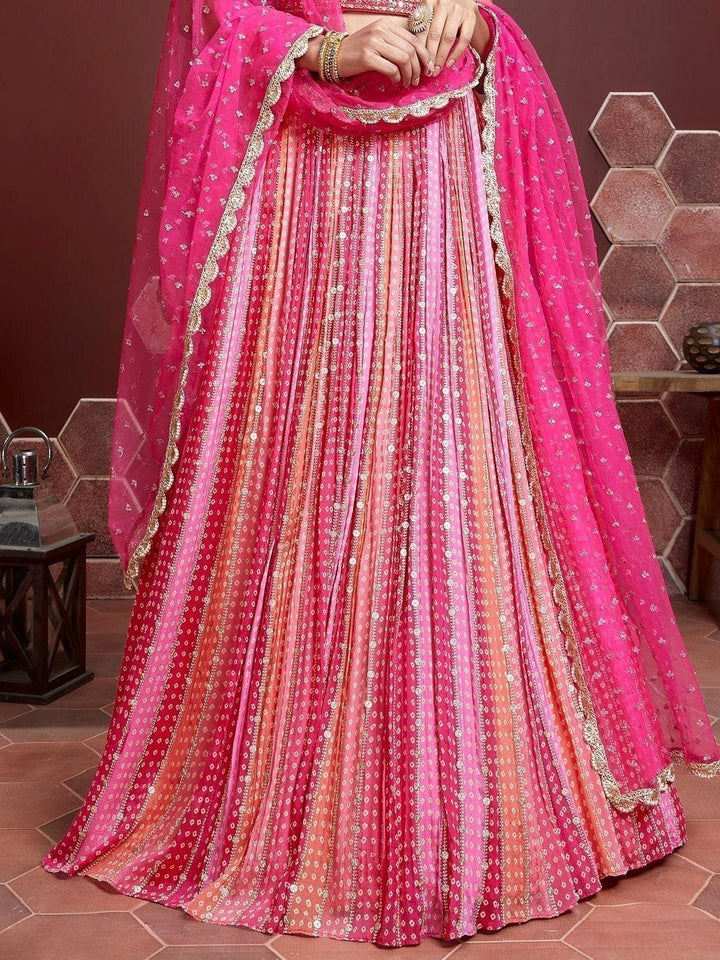 Traditional pink lehenga with sequins and zari work for weddings.