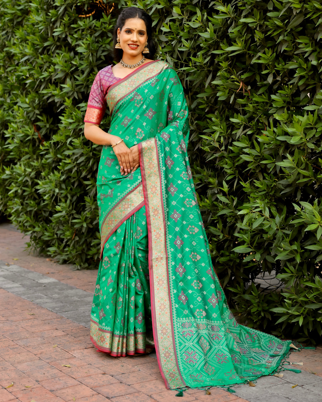 Featuring intricate Ikkat work and contrast Zari borders, this mint green Patola silk saree is the perfect choice for special occasions.