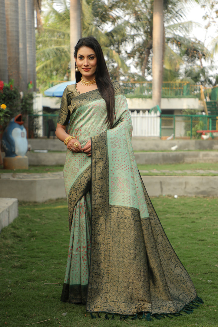 Elegant green Kanjivaram silk saree with vibrant hues and intricate work for festive gatherings.