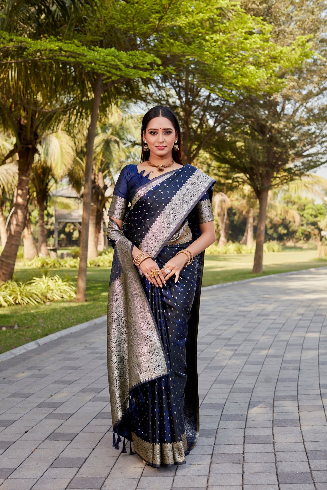 Timeless navy Soft Satin Kanjivaram saree with intricate butta and shimmering texture.