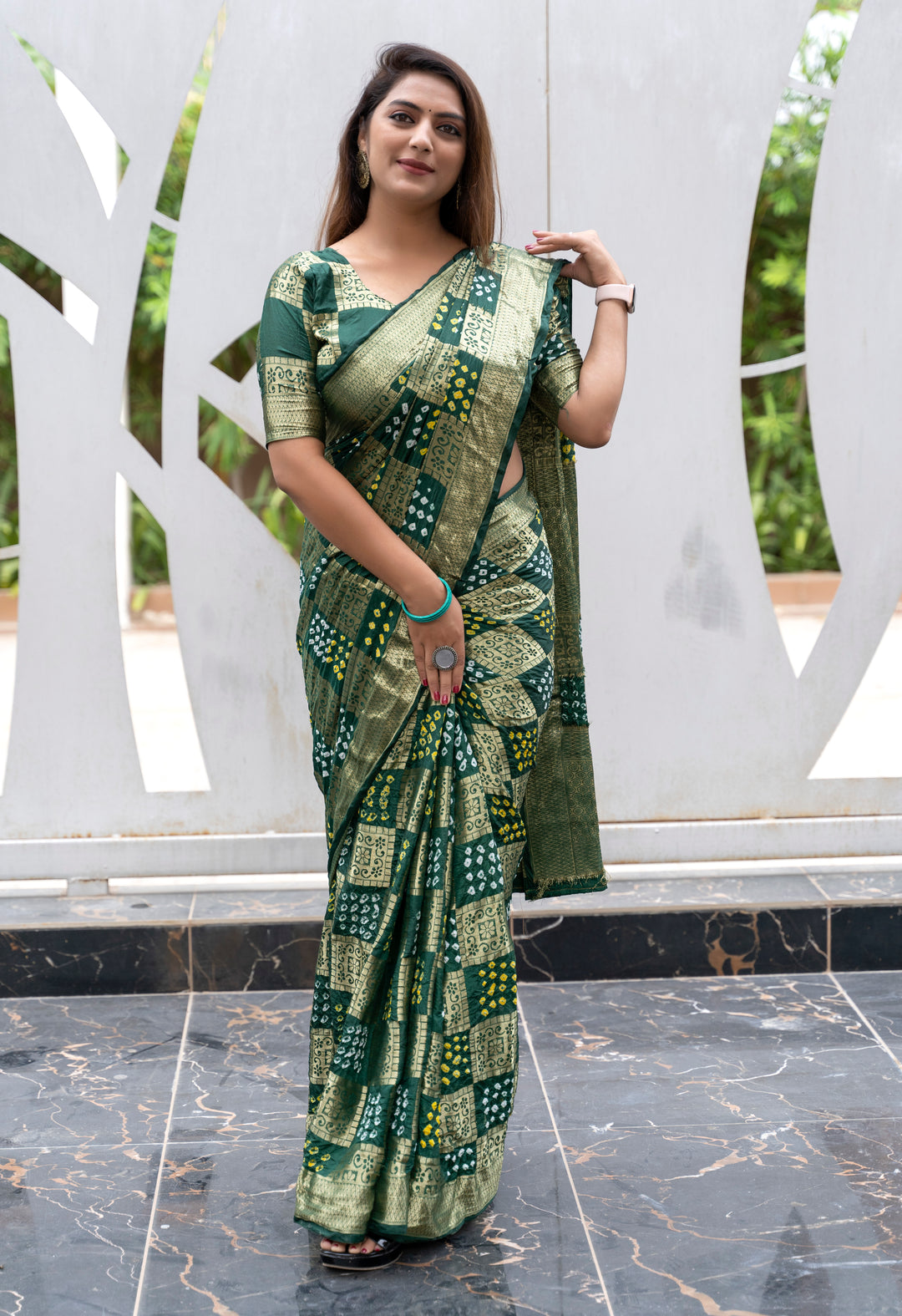 Elegant magenta Bandhej silk saree with a delicate zari border and eye-catching drape, perfect for festive celebrations.