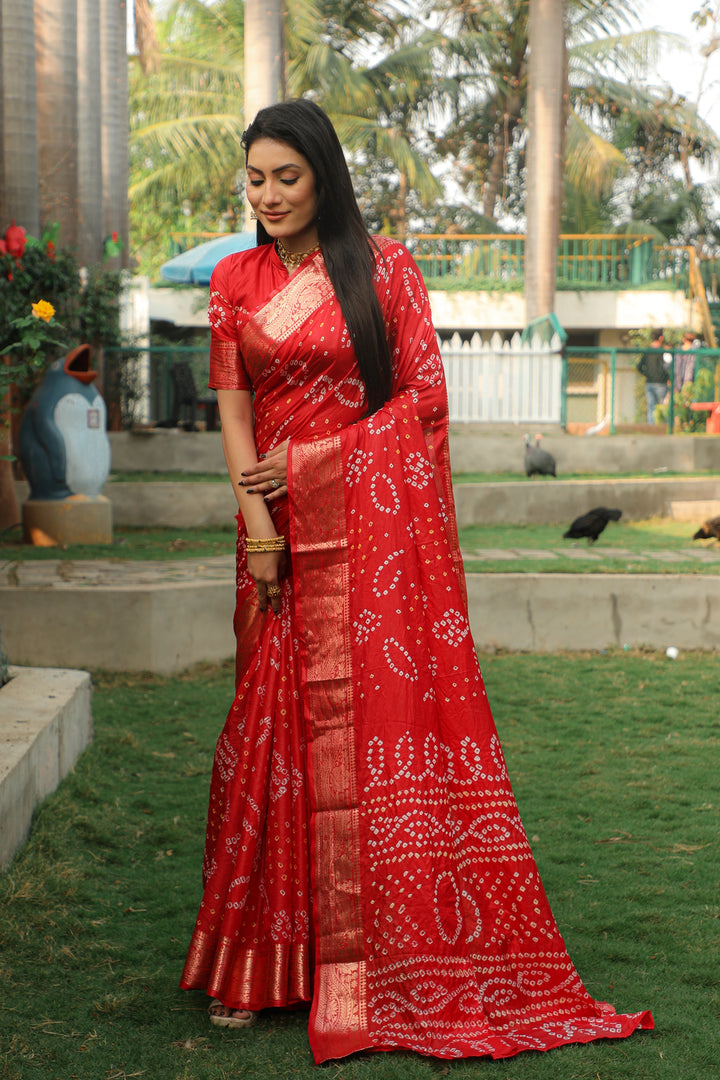 Classic red Bandhej silk saree with intricate jari weaving border, perfect for weddings and festive gatherings.