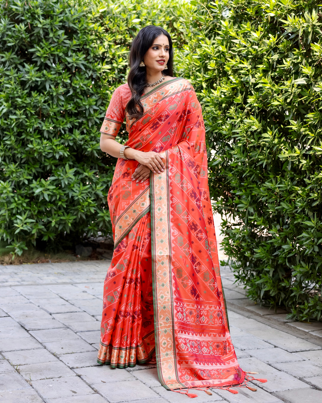 Stunning orange Bandhej silk saree with zari woven pallu and matching blouse, ideal for traditional wear.