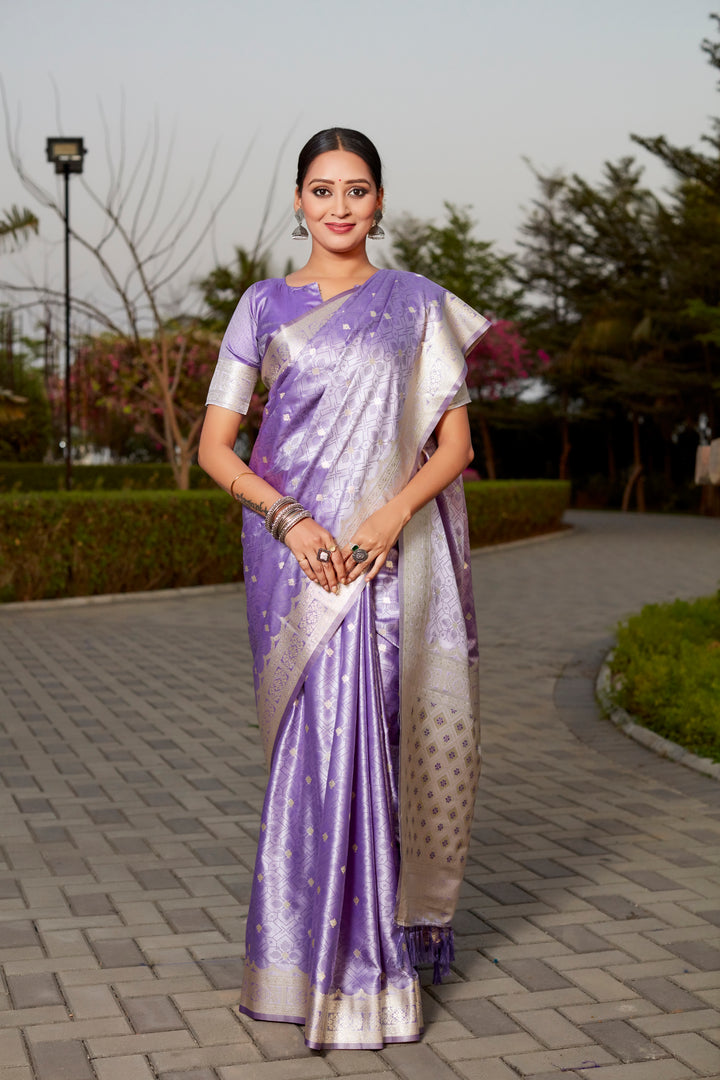 Beautiful purple Kanjivaram silk saree with intricate butta work and designer border, perfect for traditional celebrations.