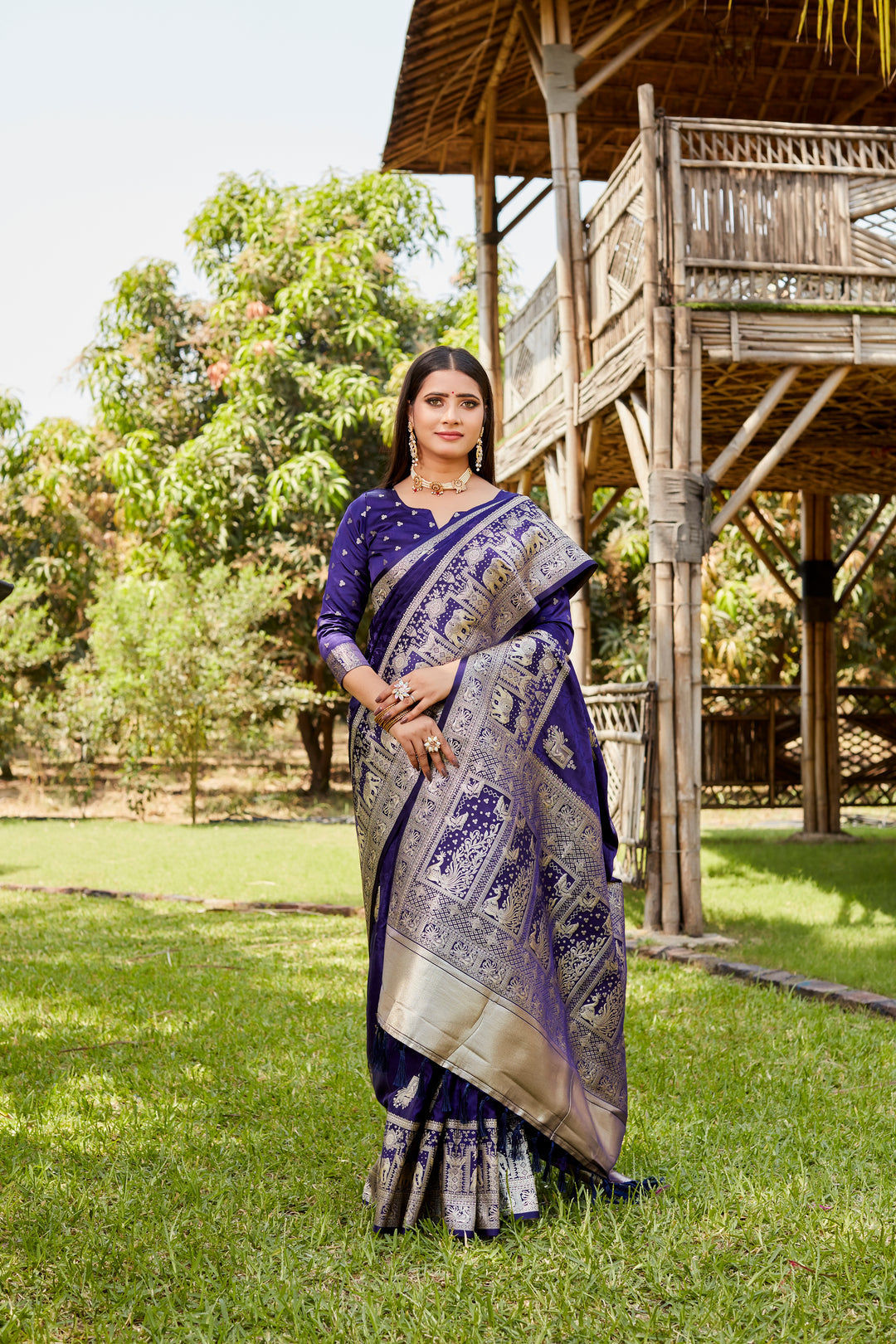 Rich navy satin Kanjivaram saree with a traditional elephant border, perfect for cultural and festive gatherings.